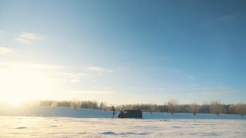 Men push broken car with engine problems in sunny winter day Stock Footage 92573629