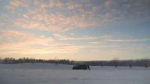 Men pushing broken car with engine problems in winter evening Stock Footage 83267861