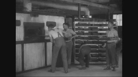 Men put the dough rolled for breads in the oven to bake - 1917-1918 Vídeos de archivo 83702513