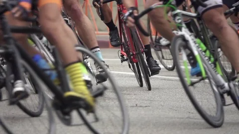 Men racing in a road bike bicycle race, super slow motion. Stock Footage