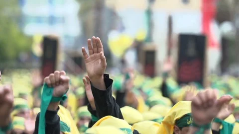 Men raise hands while calling slogans during Hezbollah's Ashoura procession Stock Footage 120589748