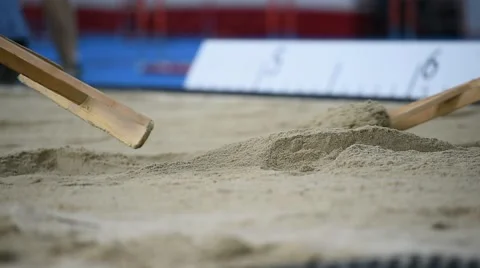 Men raking the sand in the sandpit 스톡 동영상 62522927