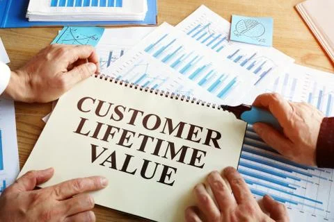 Men read Customer lifetime value conception in book. Stock Photos