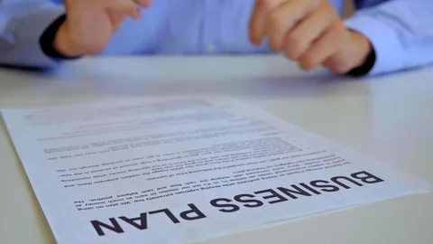Men reading business plan in 4k (UHD) Stock Footage 122920518