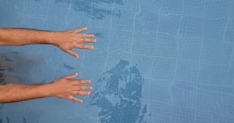 Men refreshing and swinging his hands in the swimming pool -  playing in pool Stock Footage 138326094