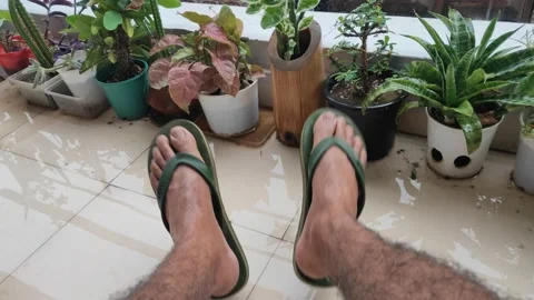 Men refreshing and swinging or swaying his legs in the rainy or wet season Stock Footage 132081080