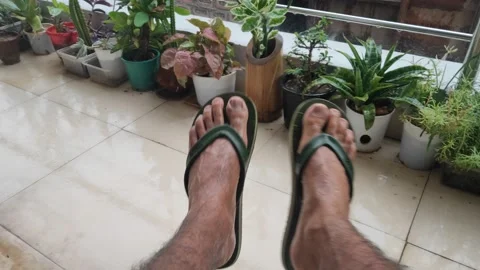 Men refreshing and swinging or swaying his legs in the rainy or wet season Stock Footage 132081102