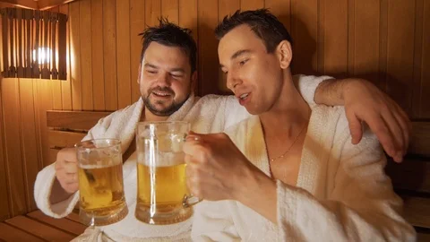 Men relax in the bath, sauna, drink beer | Stock Video | Pond5