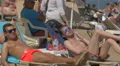 Men relaxing and smoking on the beach in Barcelona 4k or 4k+ Resolution