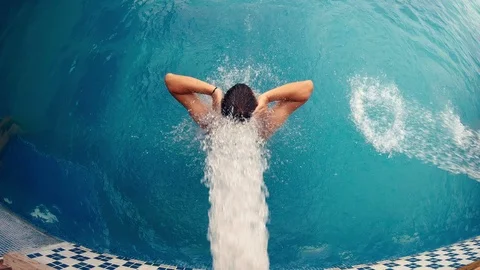 Men relaxing in spa pool under waterfall jet Stock Footage 114050113