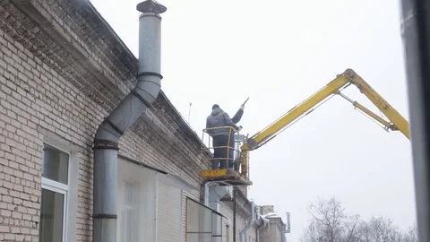 Men removing icicles Stock Footage 72124934