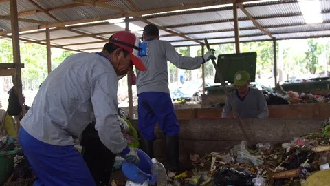 Men in respirators sort garbage. rake collect waste. in plastic bags Stock Footage 127369130
