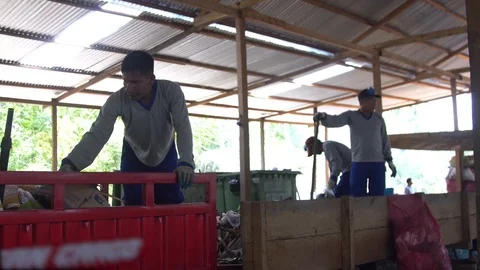 Men in respirators sort garbage. shovels scoop up waste. plastic products Stock Footage 127368850