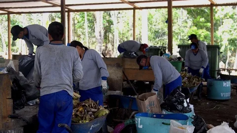 Men in respirators sort garbage. shovels scoop up waste. plastic products Stock-Footage 127369770