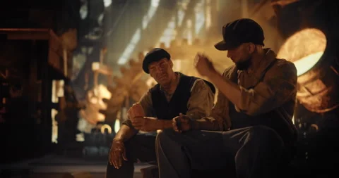 Men Resting Having Lunch in an Old Foundry Stock Footage 320869400