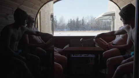 Men resting inside traditional wooden sauna Stock Footage 346691853