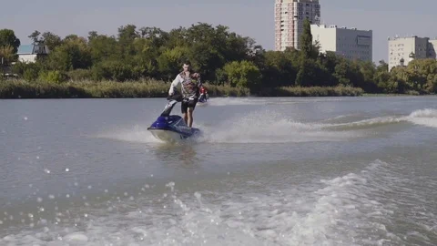 Men ride a jetski on a river Vídeos de archivo 96218569