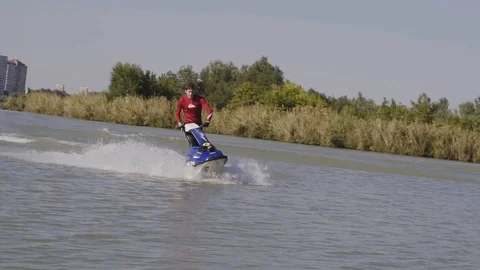 Men ride a jetski on a river Vídeos de archivo 96219374