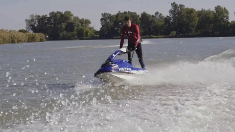 Men ride a jetski on a river Vídeos de archivo 96219491