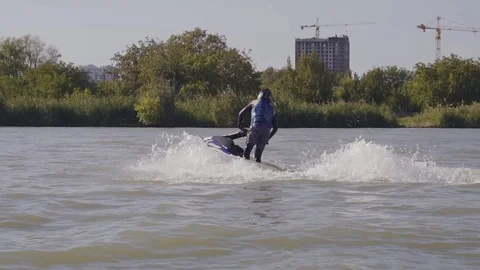 Men ride a jetski on a river Vídeos de archivo 96219595