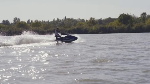 Men ride a jetski on a river Vídeos de archivo 96219615