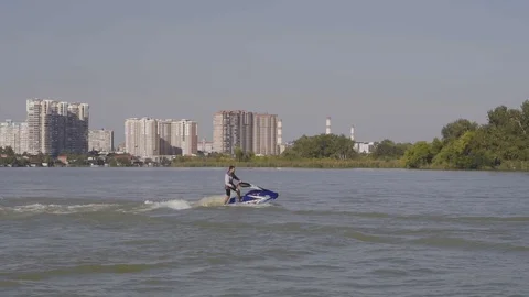 Men ride a jetski on a river Vídeos de archivo 96219796