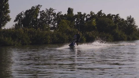 Men ride a jetski on a river Stock Footage 97145659