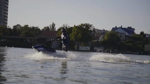 Men ride a jetski on a river Stock Footage 97146292