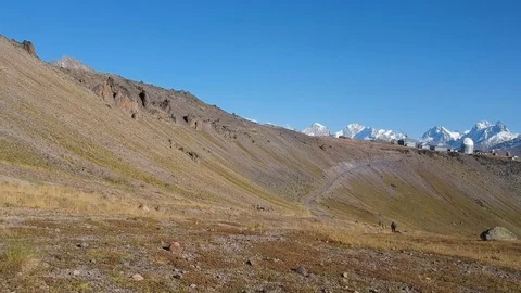 Men rides around the field in high mountains. Stock Footage 83735442