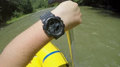Men rob with a paddle on rafting boat. Rafting boat on the fast mountain river Stock Footage 77314665