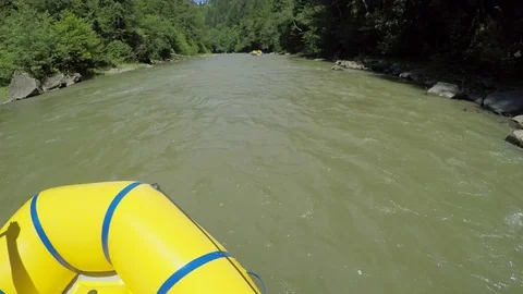 Men rob with a paddle on rafting boat. Rafting boat on the fast mountain river Stock Footage 77314965
