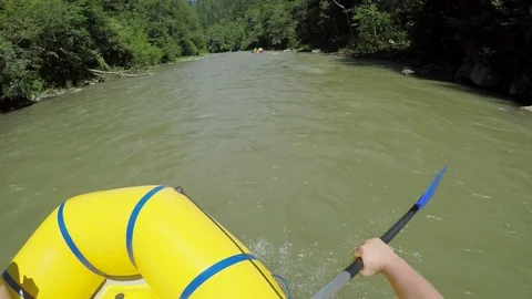 Men rob with a paddle on rafting boat. Rafting boat on the fast mountain river Stock Footage 77315245