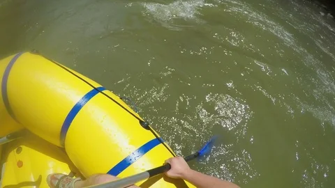 Men rob with a paddle on rafting boat. Rafting boat on the fast mountain river Stock Footage 77316557