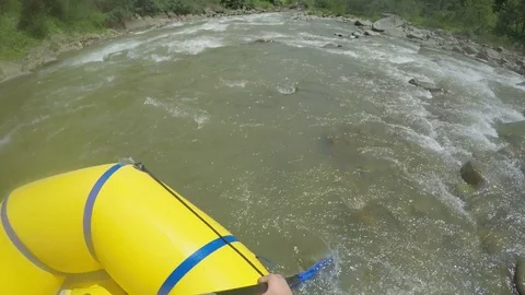 Men rob with a paddle on rafting boat. Rafting boat on the fast mountain river Stock Footage 77337124