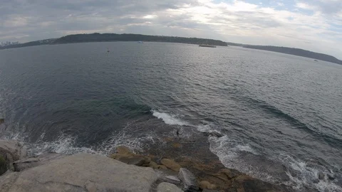 A men on the rocky beach Stock Footage 122361001