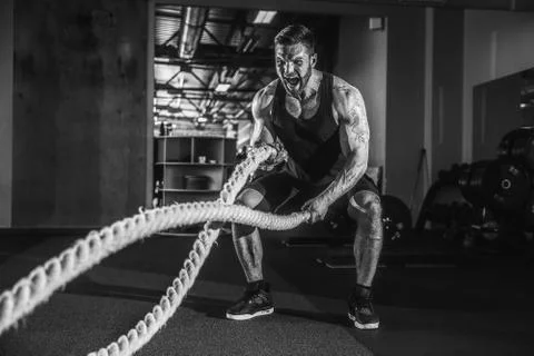 Men with rope in functional training gym Foto stock