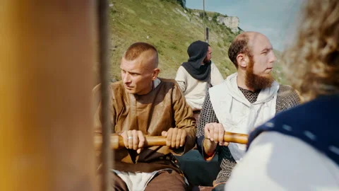 The Men Row the Oars Diligently Towards Adventure. Medieval Reconstruction. Stock Footage 163959403