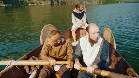 The Men Row the Oars Diligently Towards Adventure. Medieval Reconstruction. Stock Footage 163966302