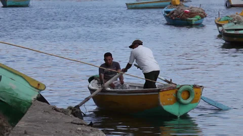 Men rowing on a boat in Alexandria, Egypt Stock Footage 34669983