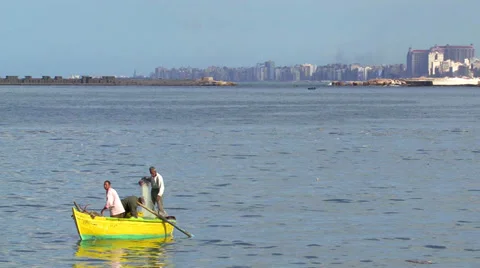 Men rowing a canoe in Alexandria, Egypt Stock Footage 32208519