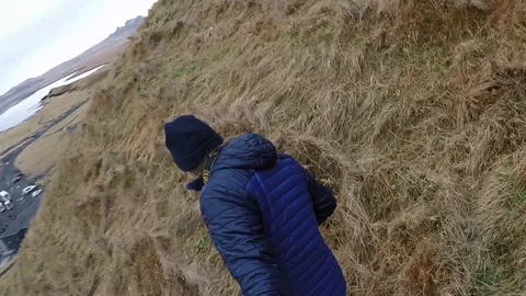 Men run downhill and fall with camera Stock Footage 124146621