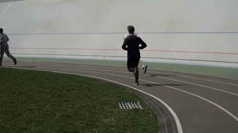 Men running along the treadmill at the stadium Stock Footage 94670106