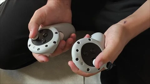 Men s gloved hands for playing VR glasses .Teen malchik is playing video games Stock Footage 313266741