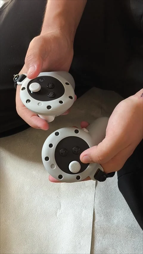 Men s gloved hands for playing VR glasses .Teen malchik is playing video games 動画素材 313266914