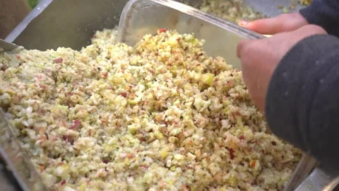 Men 's hands are raking out crushed apple paste for cider production mushed by Stock Footage 167701782