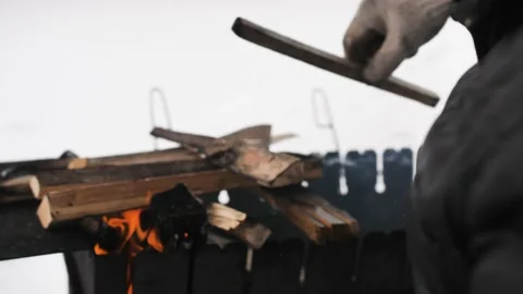 Men s hands in construction gloves spread the log on the grill. Stock Footage 150480052