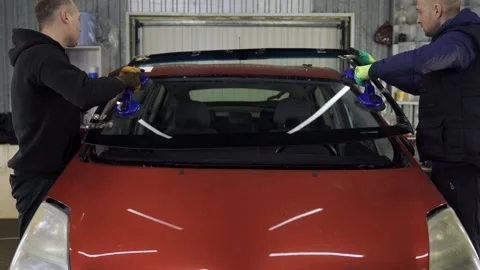 Men Сarry Glass. Replacing a New Driver's Windshield Stock Footage 218980315