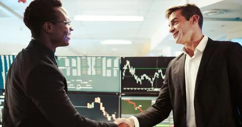 Men, screen and computer for trading with handshake of partnership, deal and Fotos Stock