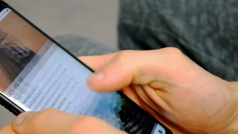 Men scrolls through instagram feed and liking photos Stock Footage 112255147