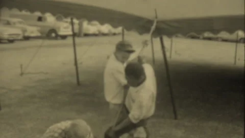 Men setting up large canopy tent outside Hillsboro High School in Nashville for  Stock Footage 230744261